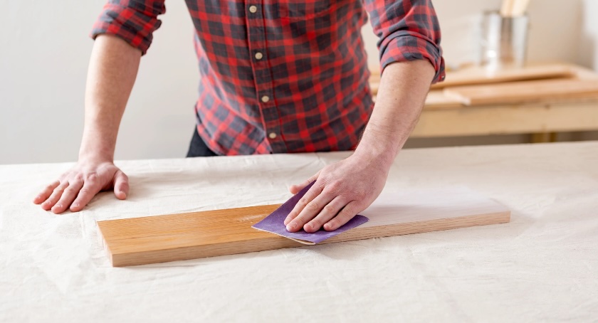 A smooth finish starts here — sanding with the grain using the right grit sandpaper ensures even stain absorption and helps reveal the wood’s natural beauty. (Source: Minwax)